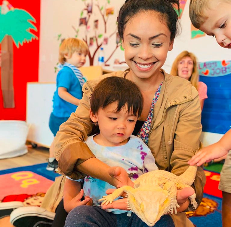 mom and boy playing with iguana at a Preschool & Daycare Serving North Hollywood, Santa Monica & Van Nuys, CA