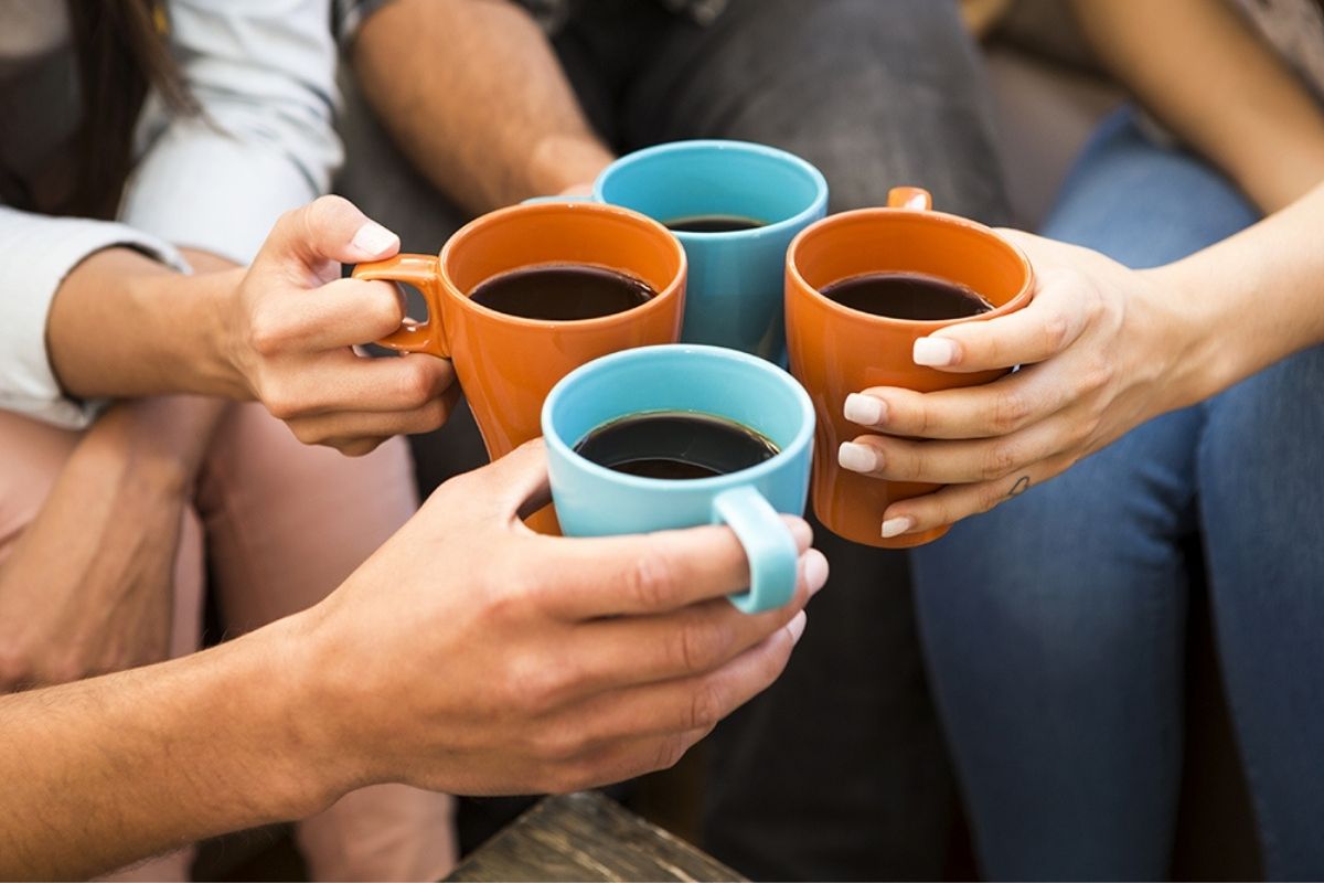 Group of people holding coffee