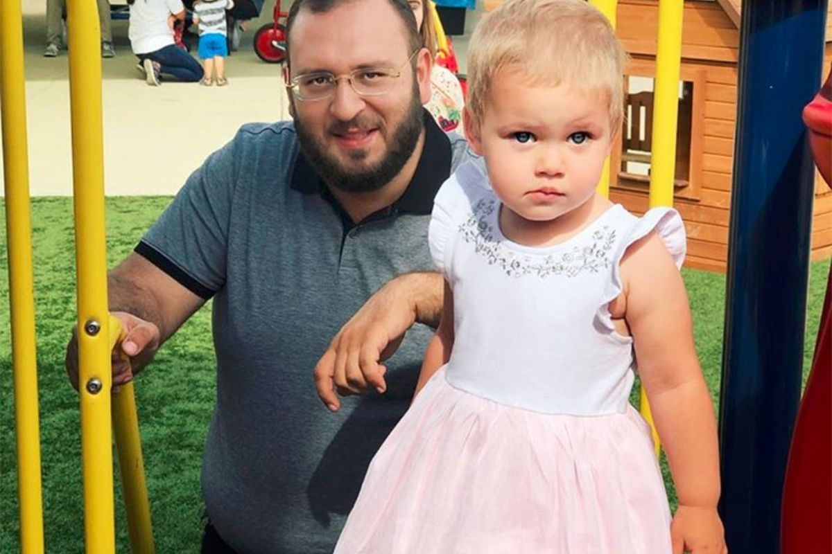 Dad and daughter play in the playground