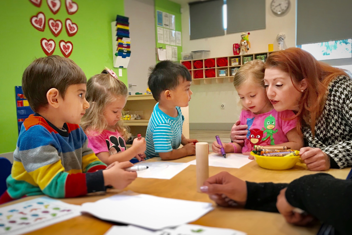 Teacher with toddlers drawing