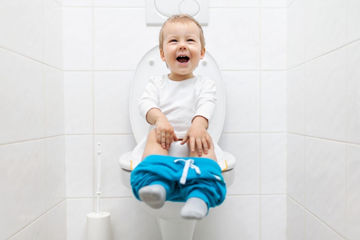 Adorable young child sitting on the toilet at a Preschool & Daycare Serving North Hollywood, Santa Monica & Van Nuys, CA
